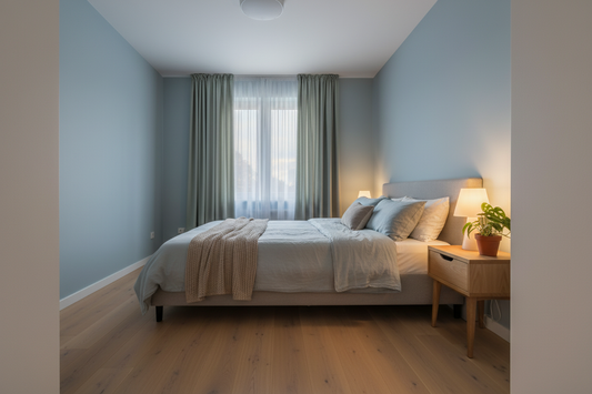 Cozy modern bedroom with soft blue walls and natural light creating a relaxing atmosphere