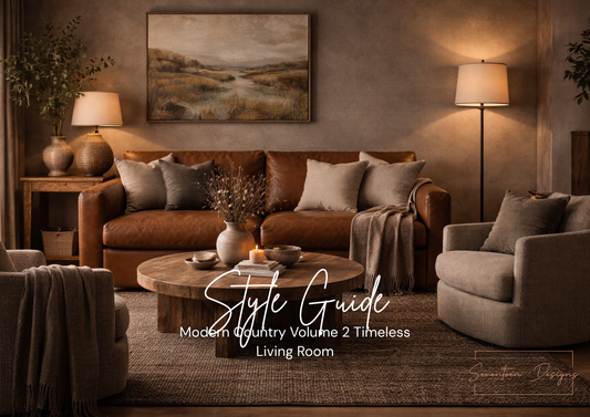 Modern country living room with brown sofa, gray armchair, and round wooden coffee table.